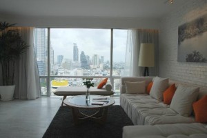 Pullman Bangkok Hotel G living room with sofa and a view
