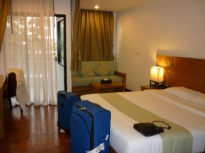 Areca Lodge bedroom with sofa and balcony