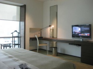 Le Meridien Bangkok Hotel view from the other side of the bed with TV and balcony